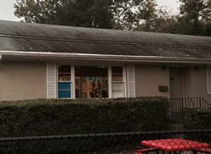 The roof of a house in need to be pressure washed